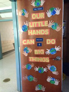 a door decorated with handprints and the words, our little hands can do