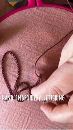 a person is making a bead necklace with beads on it and the words hand embroidery lettering