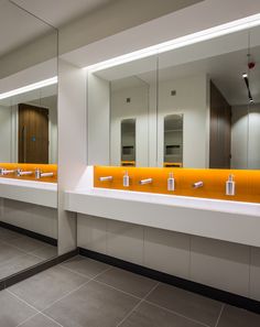 a public restroom with two sinks and mirrors
