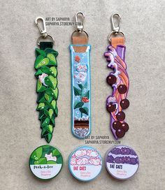 four different key chains with buttons attached to them