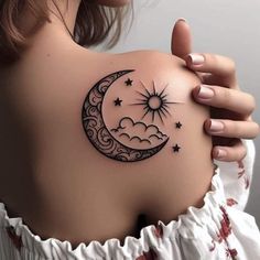 a woman's shoulder with a crescent and stars tattoo on it