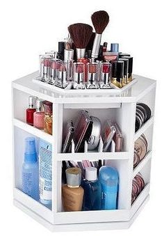 a white shelf filled with lots of cosmetics and beauty products on top of each other