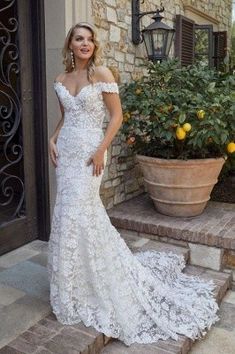 a woman in a wedding dress standing on steps