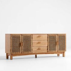 a wooden sideboard with four drawers and wicker doors on the front, against a white background
