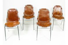 four brown leather chairs with metal legs