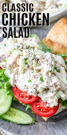 a chicken salad with lettuce, tomatoes and cucumbers on a plate