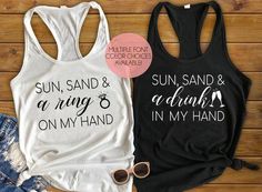 two tank tops that say sun, sand and a drink on my hand in black and white