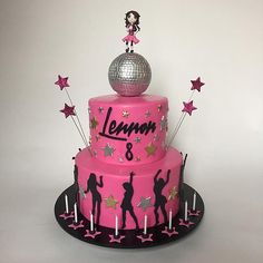 a pink birthday cake decorated with stars and a disco ball on top that says lemon 8