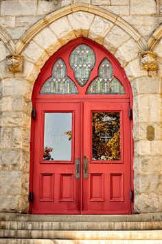 a red door with stained glass on it