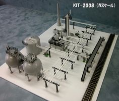 a model of an industrial area with pipes and tanks