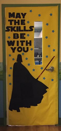 a door decorated to look like darth vader with the words may the skills be with you