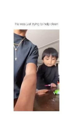 a man holding a child with toothbrushes in his hand and the caption reads he was just trying to help clear