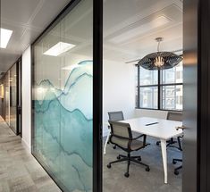 an office with glass walls and desks