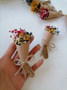 two small cones with flowers tied to them