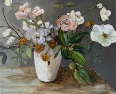 a painting of flowers in a white vase on a wooden table with grey wall behind it