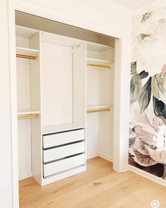 an empty closet with floral wallpaper on the walls and wooden flooring in front of it