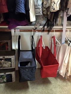 the closet is full of clothes and handbags hanging from hooks, bags on hangers