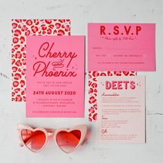 a pink and red wedding suite with sunglasses on the side, cheetah and phoein