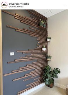 the wall is made out of wooden planks and has plants in pots on it