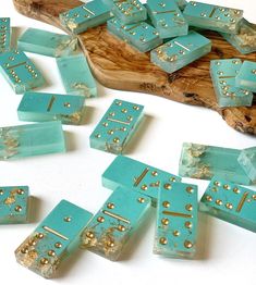 several pieces of turquoise colored wood with gold rivets