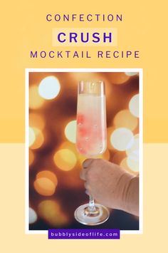 a hand holding a wine glass with liquid in it and the words, confection crush cocktail recipe