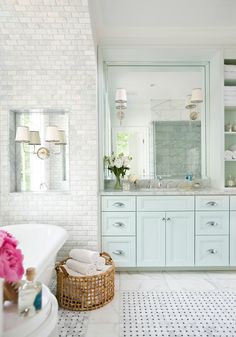 a bathroom with white tile and blue accents on the walls is featured in an instagram