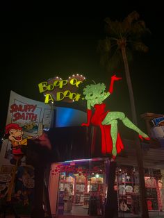 a neon sign that says happy birthday and a woman dancing in front of a store