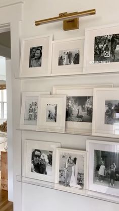 a wall with many pictures hanging on it