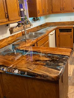 a kitchen with wooden cabinets and marble counter tops in the middle of it's island