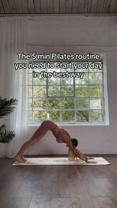 a woman is doing yoga in front of a window with the words, this 5 min pilates routine you need to start your day in the best way