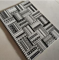 a black and white patterned notebook on a table