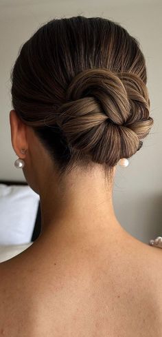 the back of a woman's head with a braid in her hair