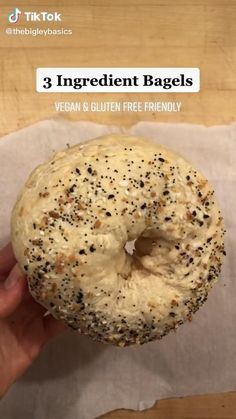 a person holding a bagel in their hand with the text, 3 ingredient bagels vegan & gluten free friendly