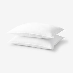 two white pillows sitting on top of each other
