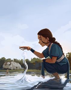 a woman kneeling down in the water holding her hand out to catch something with it