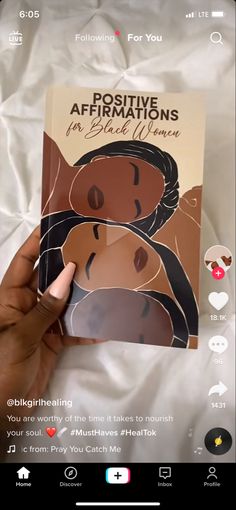 someone is holding up a book with the cover pulled back to show it's image