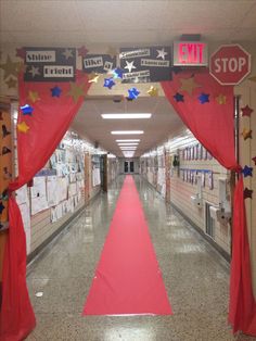 an empty hallway with red carpet and decorations