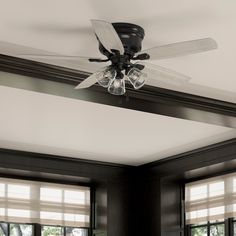 a ceiling fan with three lights in a room