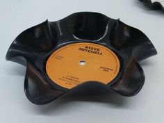 a black and yellow record sitting on top of a table