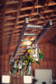 some flowers are hanging from the ceiling in a room with wood paneling and beams