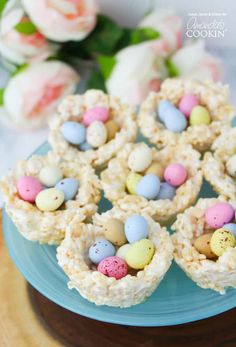 mini egg rice krispies nests on a blue plate with flowers in the background