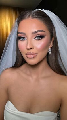 a woman wearing a wedding veil and makeup