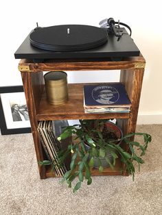an old record player on top of a wooden shelf