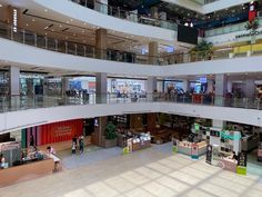 the inside of a shopping mall with people walking around