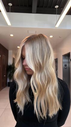 creamy blonde with soft money piece and a lived in layered haircut