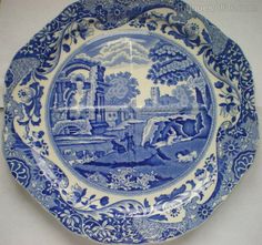 a blue and white plate with an image of a castle in the distance on it