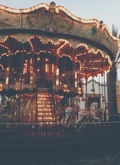 an old fashioned merry go round with lights