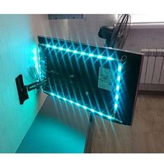 a large mirror with lights on it in a room next to a radiator