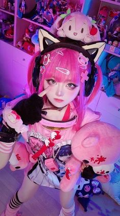 a girl with pink hair wearing headphones and holding a stuffed animal in her hands