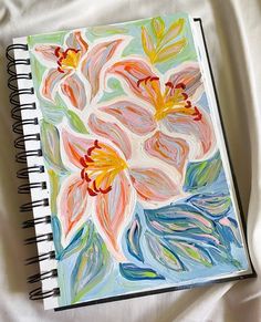 an art journal with flowers painted on it